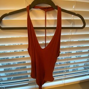 Burnt orange body suit